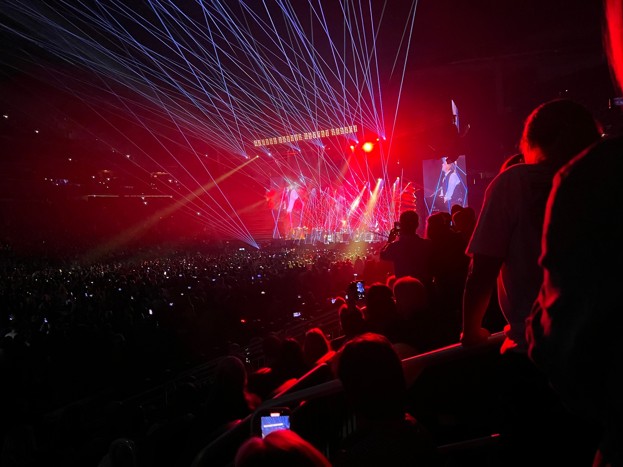 People at a music concert with laser show